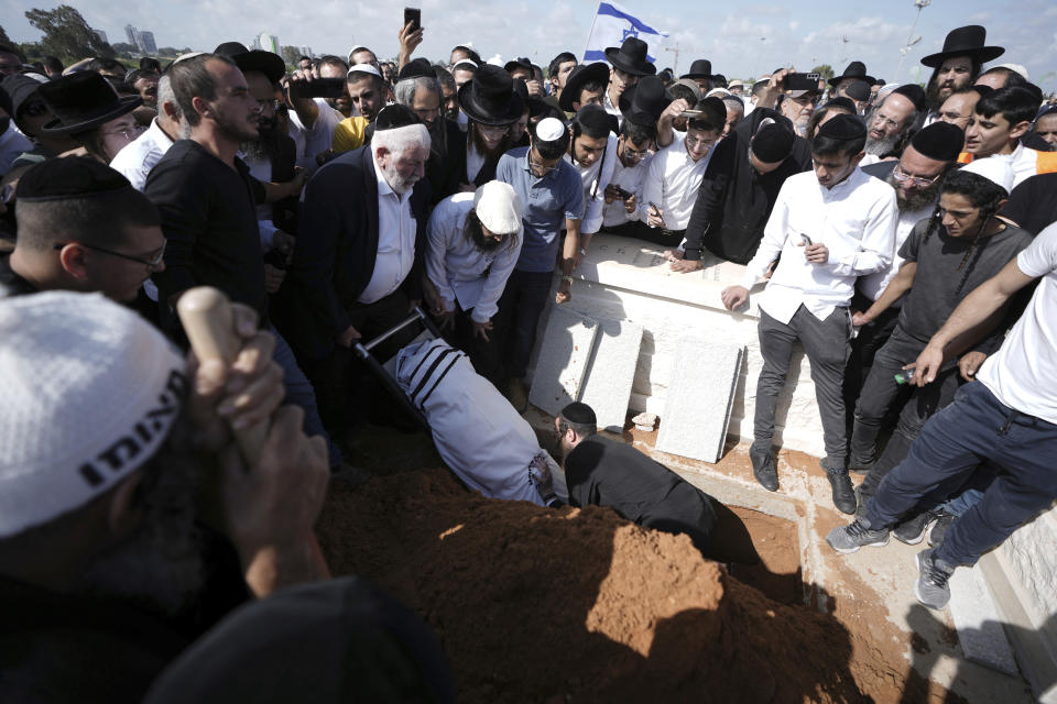 Yonatan Havakuk is buried in Petah Tikva, Israel, the day after he was killed with two others in a stabbing attack in Elad, Friday, May 6, 2022. Israeli security forces waged a massive manhunt Friday for two Palestinians suspected of carrying out the stabbing attack on Thursday near Tel Aviv that left three Israelis dead.(AP Photo/Ariel Schalit)