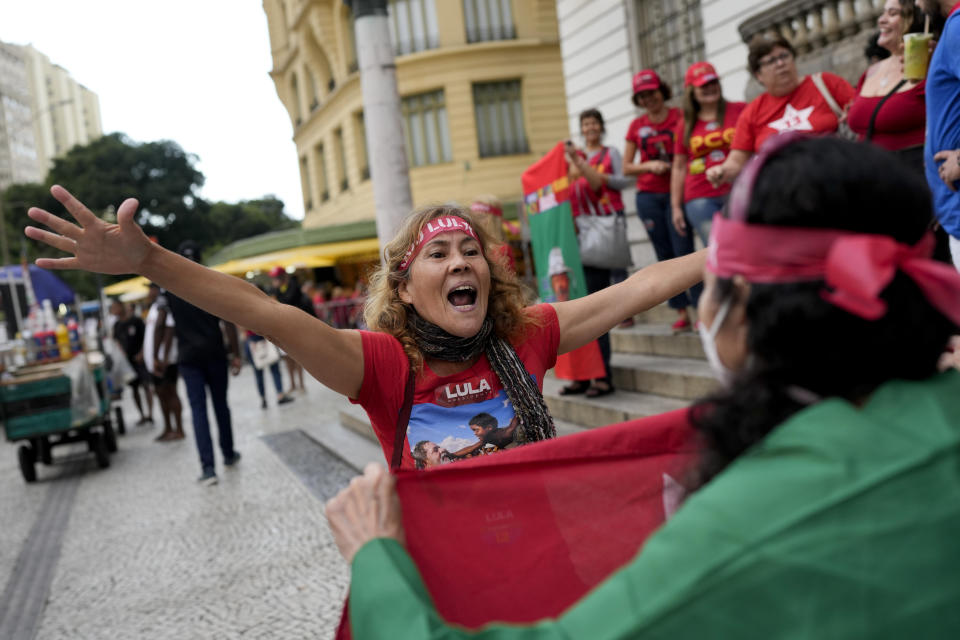 A follower of former Brazilian President Luiz Inacio "Lula" da Silva, who is running for president again, celebrates partial results after general election polls closed in Rio de Janeiro, Brazil, Sunday, Oct. 2, 2022. (AP Photo/Silvia Izquierdo)