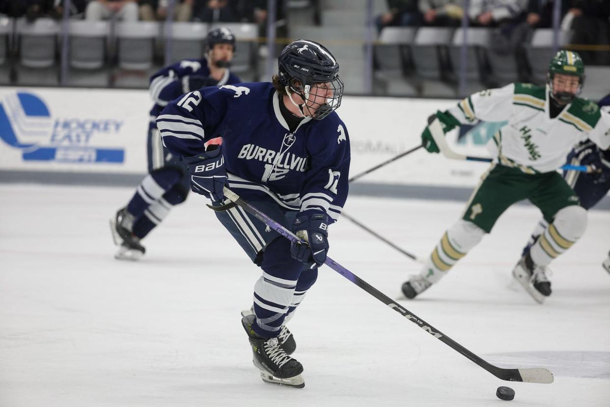 Burrillville's Evan Polacek pushes the puck up the ice against Burrillville on Sunday,