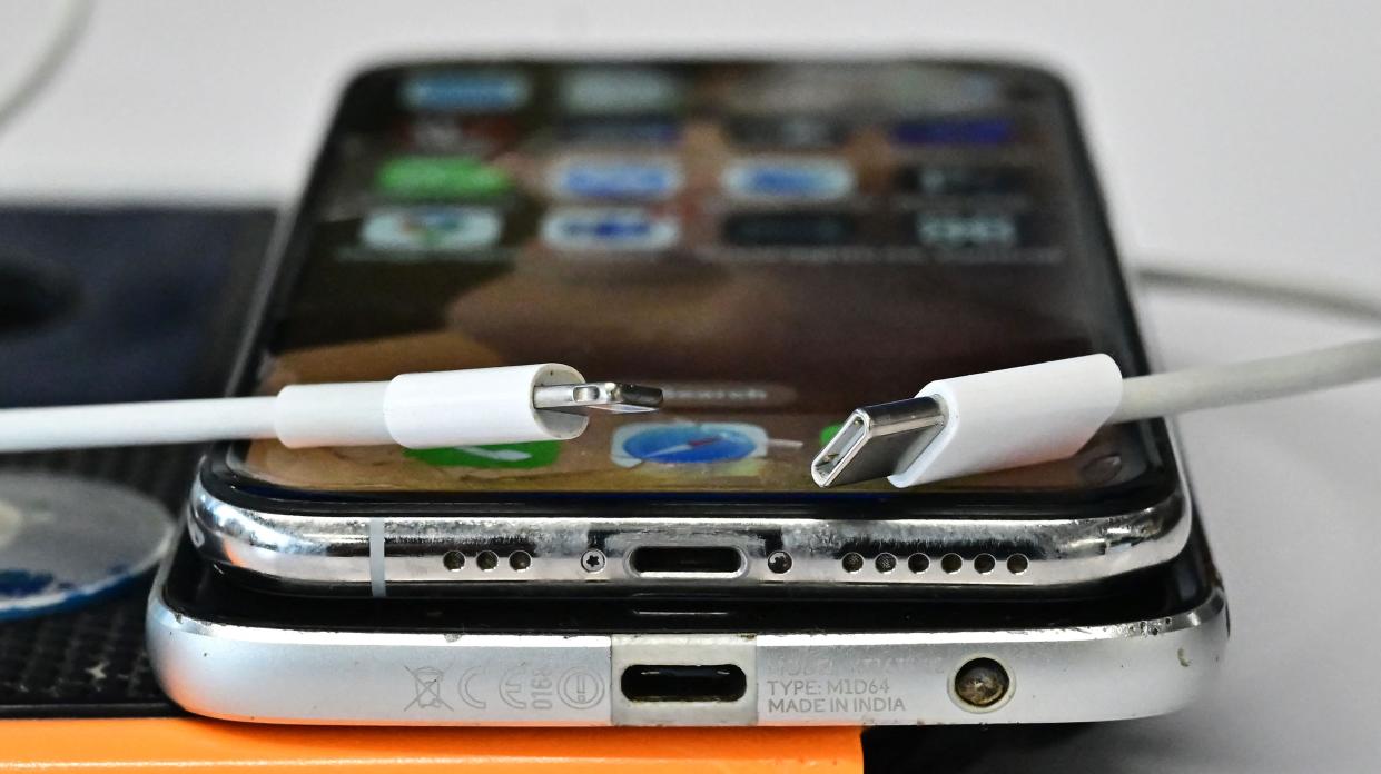 A USB-C charger (R) and a traditional Apple Lightning charger (L) are seen on an Apple iPhone with Lightning port above an Android phone with a USB-C port on Sept. 11, 2023, in Los Angeles. The new Apple iPhone 15, with an EU ordered USB-C charger, was announced during a launch event on Sept. 12, 2023.