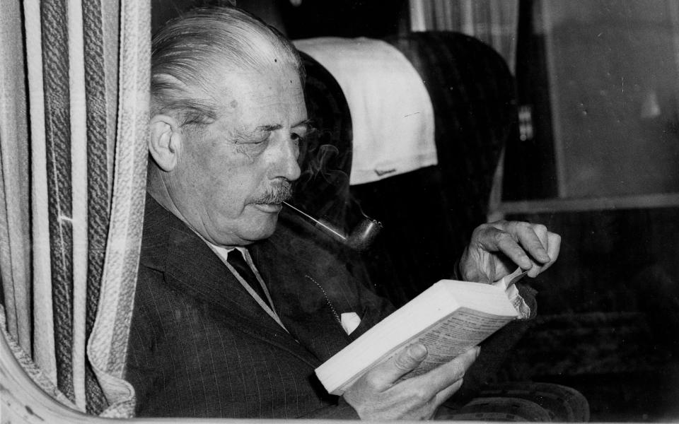 Harold Macmillan reading on a train from King's Cross, London