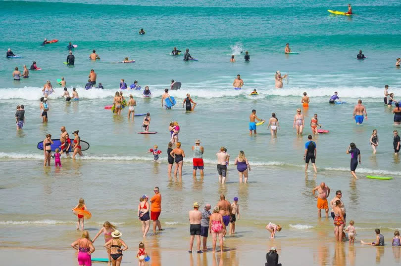 Sunbathers take to the sea in Newquay