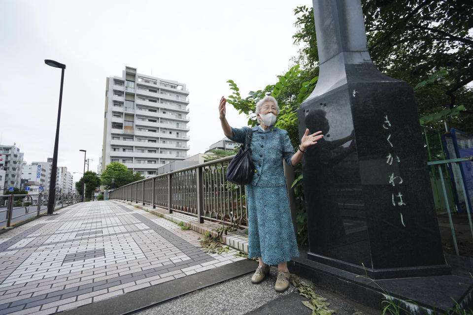 Kisako Motoki, who lost her parents and siblings to the Great Tokyo Air Raid on March 10, 1945, speaks on her war experience at Kikukawa Bridge where she escaped from air raid bombing in Tokyo Wednesday, July 29, 2020. In Japan, war orphans were punished for surviving. They were bullied. They were called trash, sometimes rounded up by police and put in cages. Some were sent to institutions or sold for labor. They were targets of abuse and discrimination. Now, 75 years after the war's end, some are revealing their untold stories of recovery and pain, underscoring Japan’s failure to help its own people. (AP Photo/Eugene Hoshiko)