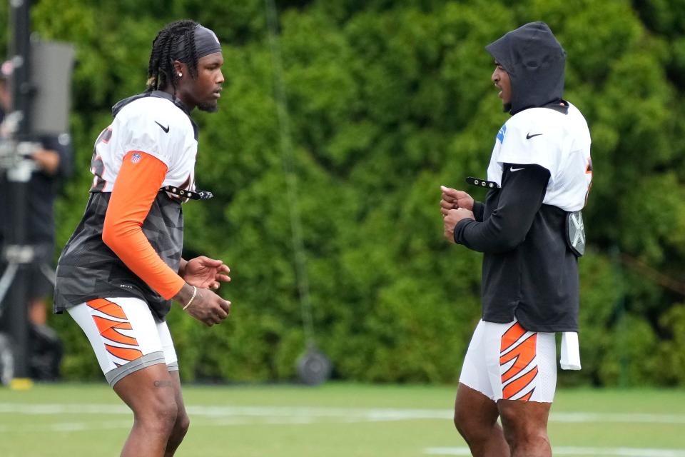 Cincinnati Bengals wide receiver Tee Higgins (85) and Cincinnati Bengals wide receiver Ja'Marr Chase (1) work together on the sideline during training camp practice at the Paycor Stadium practice facility in downtown Cincinnati on Wednesday, Aug. 10, 2022.