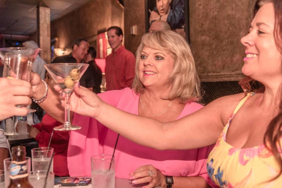 Diane McCoy, center, and her daughter Rachelle McBride hoist glasses at Touche.