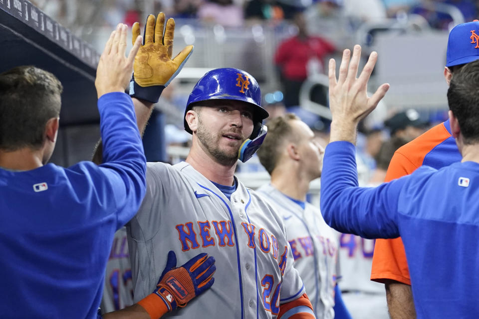 New York Mets' Pete Alonso is congratulated after hitting a solo home run during the second inning of a baseball game against the Miami Marlins, Saturday, June 25, 2022, in Miami. (AP Photo/Lynne Sladky)