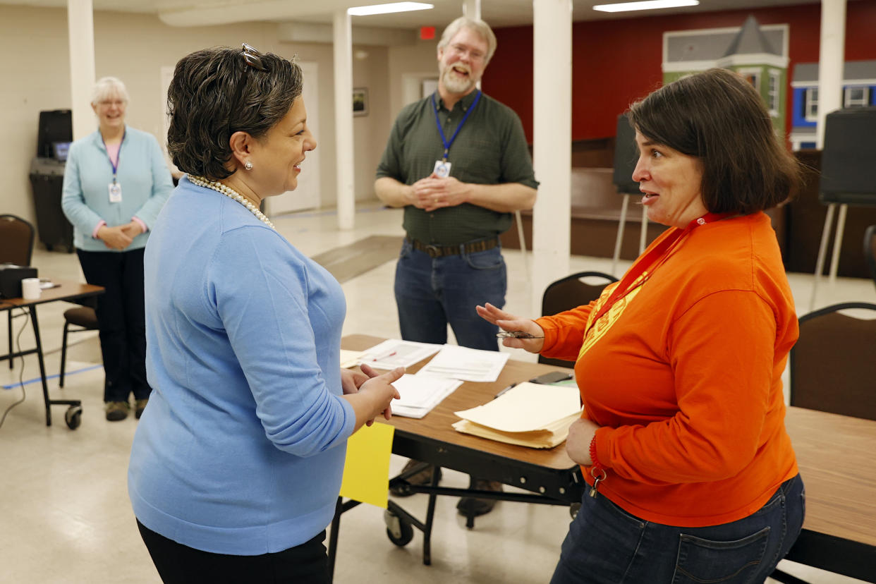 State Sen. Jennifer McClellan, D-Richmond, greets chief election officer and college friend Sheryl Johnson, right, at the Tabernacle Baptist Church polling station in Richmond, Va., on Tuesday, Feb. 21, 2023 as, from left, election workers Katie Johnson and Eric Johnson look on. McClellan is running to succeed Rep. Donald McEachin, D-4th. McClellan would be the first African American woman to represent Virginia in Congress and would give Virginia a record four women in its congressional delegation. (Eva Russo/Richmond Times-Dispatch via AP)