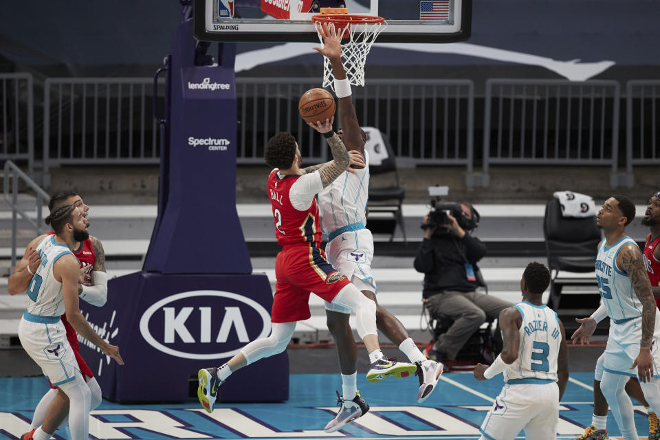 New Orleans Pelicans guard Lonzo Ball (2) tries to shoot over Charlotte Hornets center Bismark Biyombo during the second half of an NBA basketball game Sunday, May 9, 2021, in Charlotte, N.C. (AP Photo/Brian Westerholt)