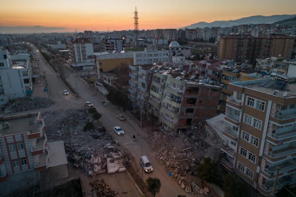 An aerial view of damaged buildings and rubble in the streets