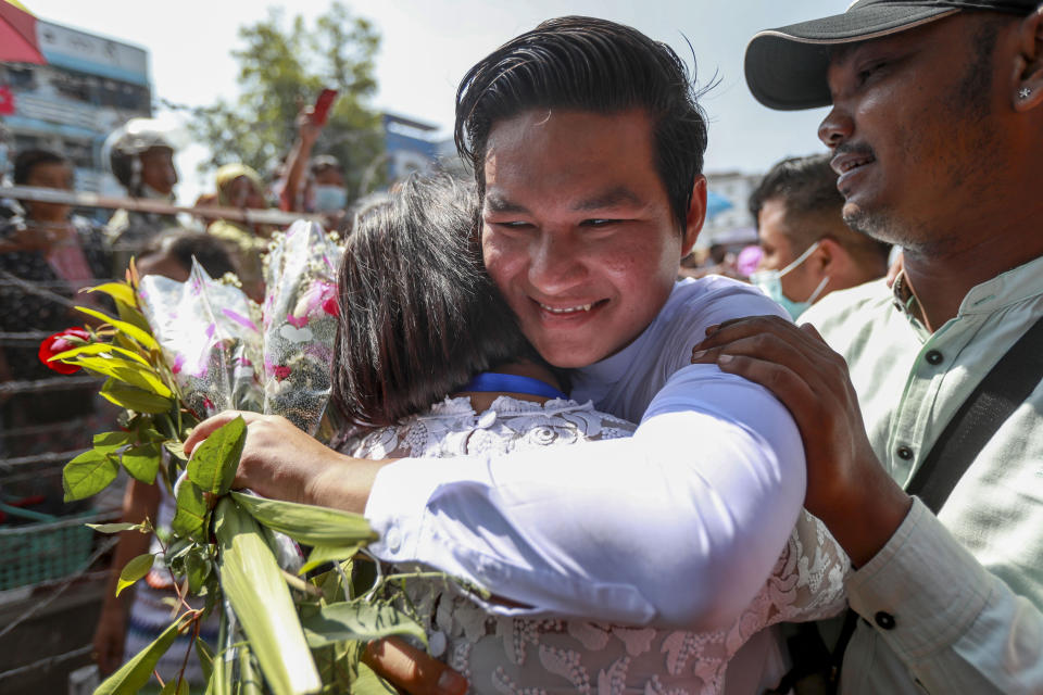 A released prisoner hugs a family member outside the Insein prison in Yangon, Myanmar Friday, Feb. 12, 2021. Myanmar's coup leader used the country's Union Day holiday on Friday to call on people to work with the military if they want democracy, a request likely to be met with derision by protesters who are pushing for the release from detention of their country's elected leaders. The new junta announced it would mark Union Day by releasing thousands of prisoners and reducing other inmates’ sentences. (AP Photo)