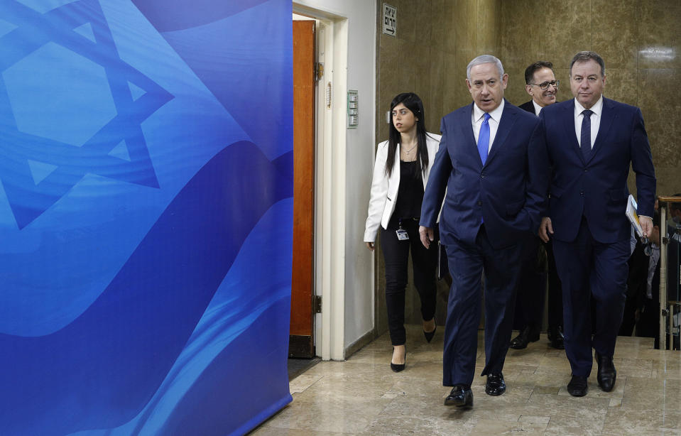 Israeli Prime Minister Benjamin Netanyahu arrives for the weekly cabinet meeting at his office in Jerusalem, Sunday Dec. 2, 2018. Israeli police on Sunday recommended indicting Prime Minister Netanyahu on bribery charge allegations related to a corruption case involving Israel's Bezeq telecom giant. (Gali Tibbon/Pool via AP)