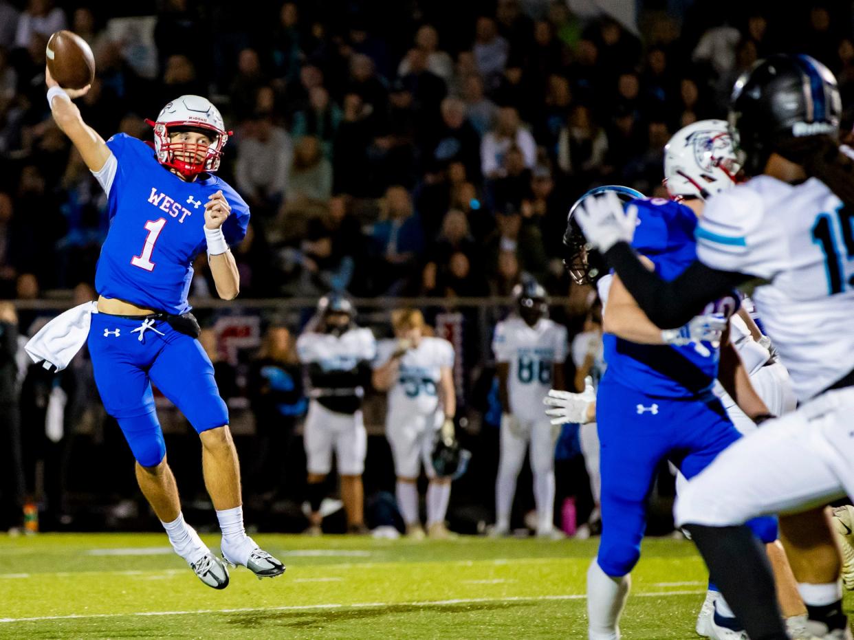 West Henderson sophomore quarterback Cade Young throws against Oak Grove Friday night in the third round of the NCHSAA playoffs at West Henderson High School in Hendersonville, NC. West defeated Oak Grove 45-24 to advance.