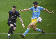 CF Montreal's Joel Waterman, left, clears the ball as Philadelphia Union's Leon Flach moves in during the second half of an MLS soccer game, Saturday, Oct. 16, 2021, in Montreal. (Graham Hughes/The Canadian Press via AP)