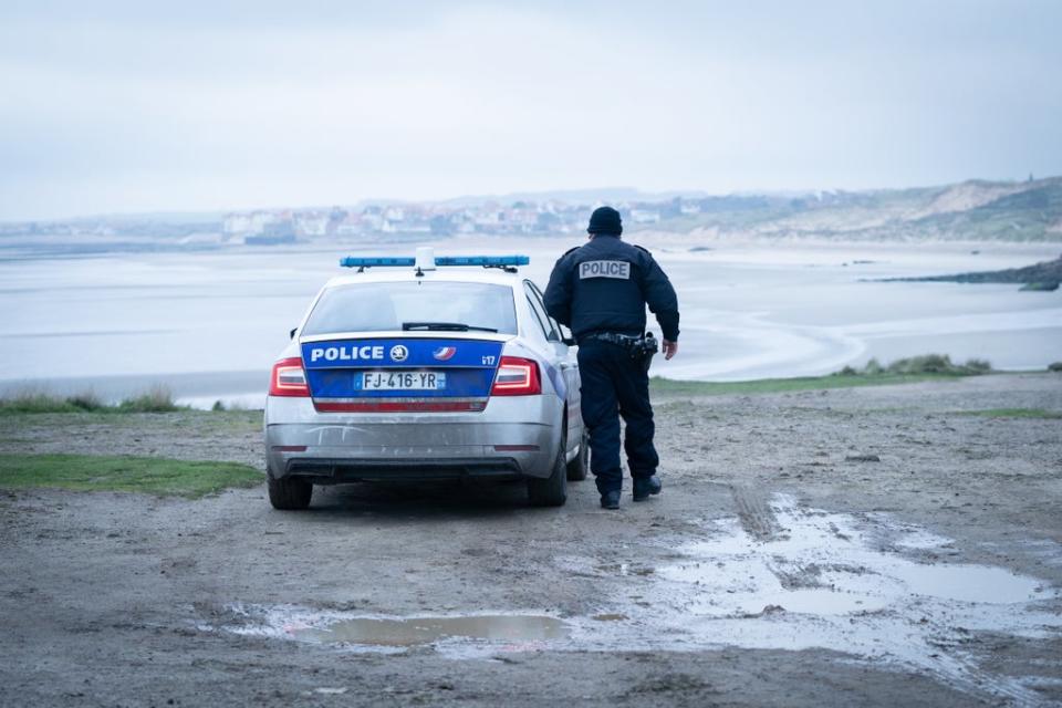 French police look out over a beach near Wimereux in France (Stefan Rousseau/PA) (PA Wire)