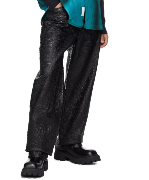 A model wearing a pair of black faux leather pants.