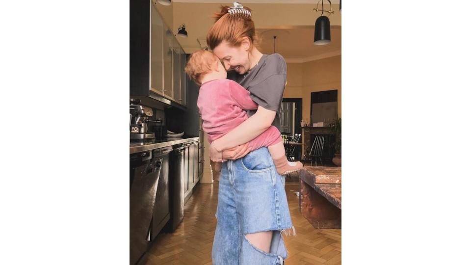 Stacey Dooley holding Minnie in the kitchen