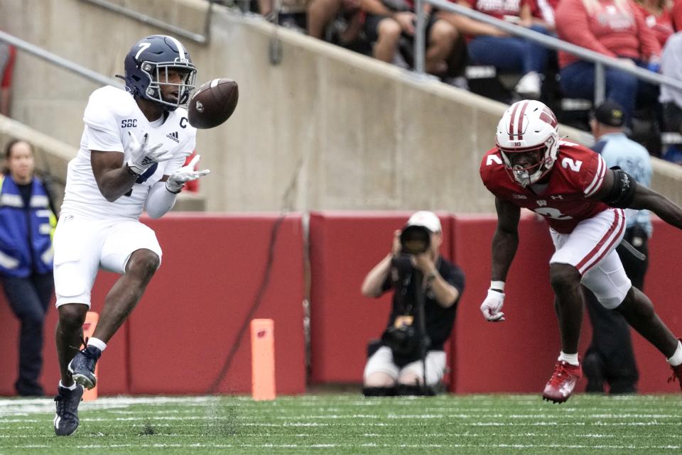 Georgia Southern's Khaleb Hood (7) catches a pass in front of Wisconsin's Ricardo Hallman (2) during the first half of an NCAA college football game Saturday, Sept. 16, 2023, in Madison, Wis. (AP Photo/Morry Gash)