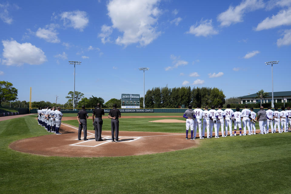 Players with North Carolina A&T State University, left, and Prairie View A&M University, right, stand for the national anthem at the Andre Dawson Classic tournament, Friday, Feb. 23, 2024, at the Jackie Robinson Training Complex, in Vero Beach, Fla. The percentage of Black major league players has been declining for decades and remains historically low, but there are signs of improvement in the league's player development pipeline. (AP Photo/Lynne Sladky)