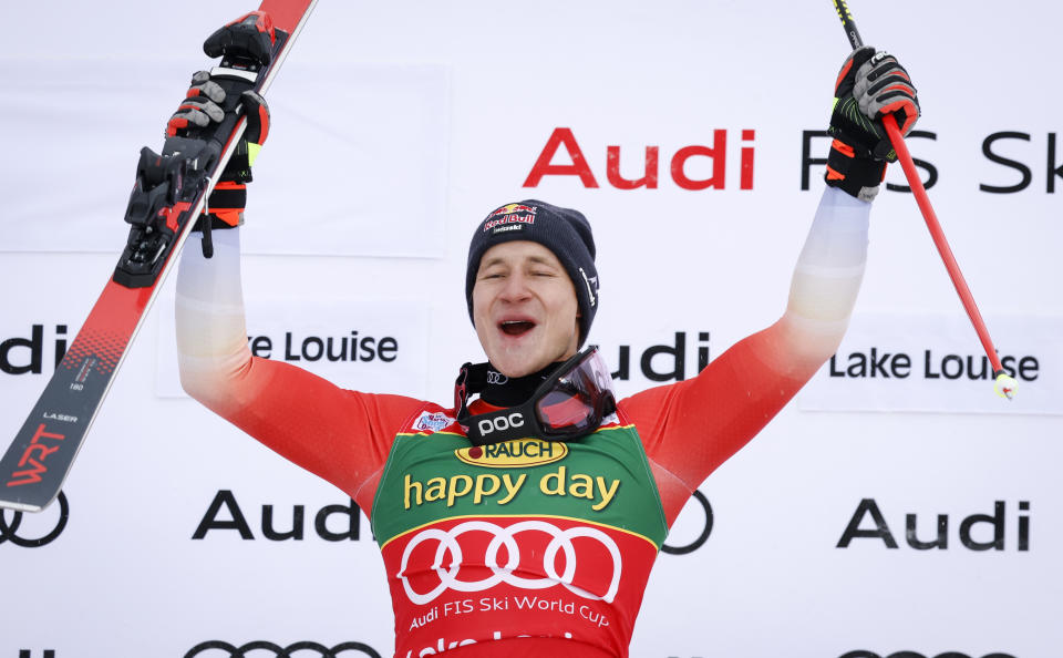 Switzerland's Marco Odermatt celebrates his victory on the podium following the men's World Cup super-G ski race at Lake Louise, Alberta, Sunday, Nov. 27, 2022. (Jeff McIntosh/The Canadian Press via AP)