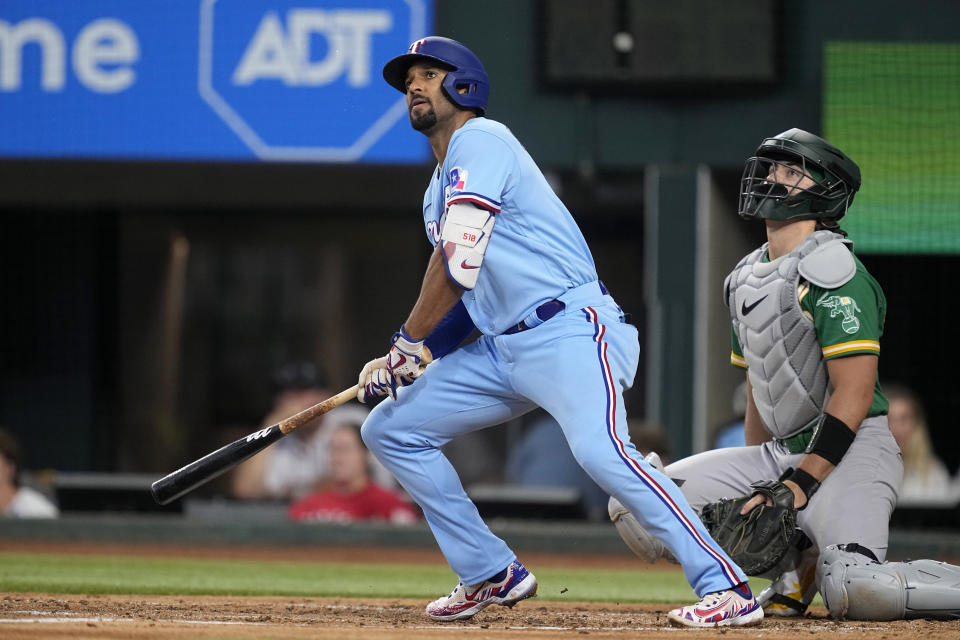 Texas Rangers' Marcus Semien and Oakland Athletics catcher Tyler Soderstrom watches Semien's double to left in the second inning of a baseball game, Sunday, Sept. 10, 2023, in Arlington, Texas. (AP Photo/Tony Gutierrez)