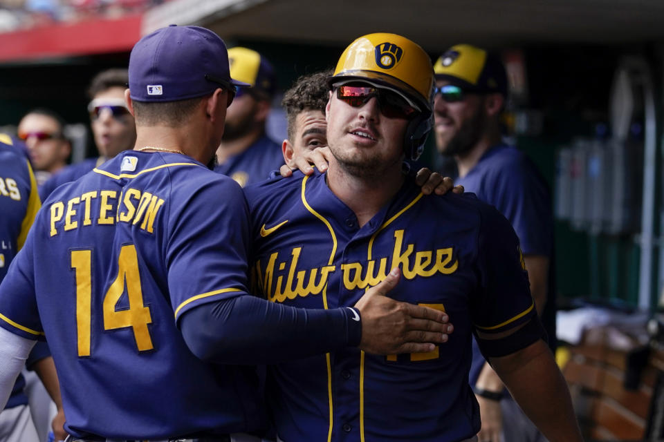 Milwaukee Brewers' Hunter Renfroe, center, celebrates with Jace Peterson (14) after hitting a solo home run during the second inning of a baseball game against the Cincinnati Reds, Sunday, Sept. 25, 2022, in Cincinnati. (AP Photo/Jeff Dean)