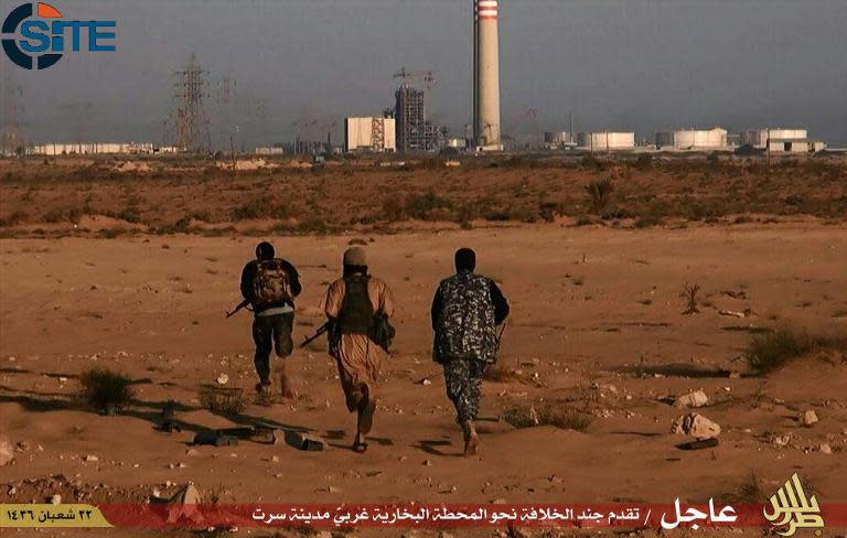 Islamic State group fighters allegedly run towards a power plant in the Libyan city of Sirte in this jihadist media outlet Wilayat Trablus image from June 9, 2015