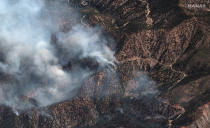 This natural color photo provided by Maxar Technologies shows fire spots from the Bobcat Fire amid an area of the Angeles Crest Highway winding through the San Gabriel Mountains, in Los Angeles County, California, Monday, Sept. 21, 2020. (Satellite image ©2020 Maxar Technologies via AP)