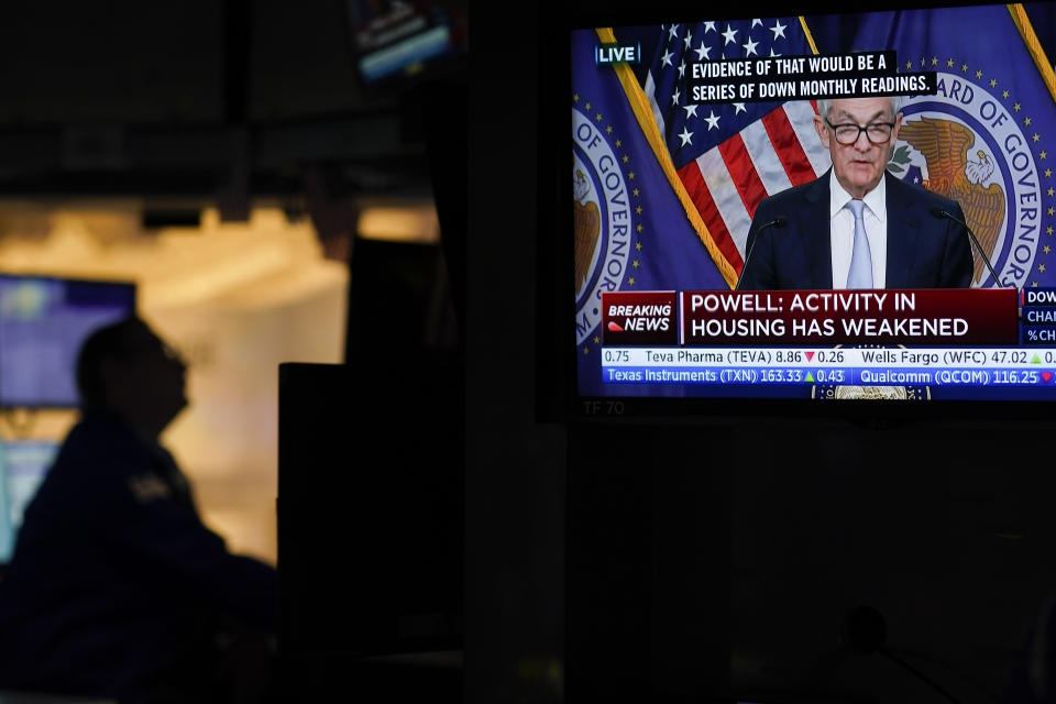 File - Traders work on the floor at the New York Stock Exchange as the Federal Reserve chairman Jerome Powell speaks after announcing a rate increase in New York, Wednesday, Nov. 2, 2022. Nearly a year into the Fed's attempts to quash inflation by hiking interest rates at a blistering speed, Wall Street investors still don't fully believe what the Fed says is coming next.(AP Photo/Seth Wenig, File)