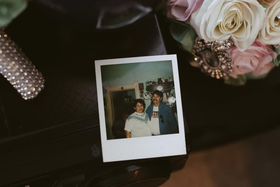Debbie Navejas Aguilar keeps a polaroid of her parents, Armando and Josephine Navejas, from a Christmas celebration many years ago.