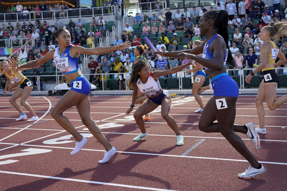 Talitha Diggs, of the United States, hands off the baton to Allyson Felix, of the United States, during a heat in the women's 4x400-meter relay at the World Athletics Championships on Saturday, July 23, 2022, in Eugene, Ore. (AP Photo/David J. Phillip)