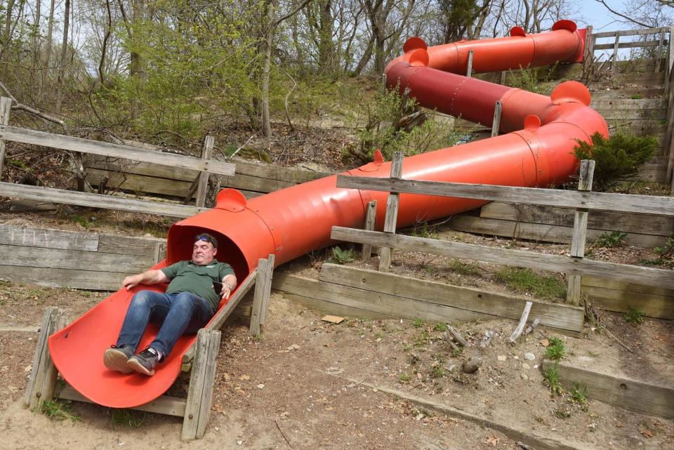 In this Herald News photo from 2018, Somerset Recreation Director Barry Fontaine comes out the end of the Big Red Slide at Pierce Beach Park.