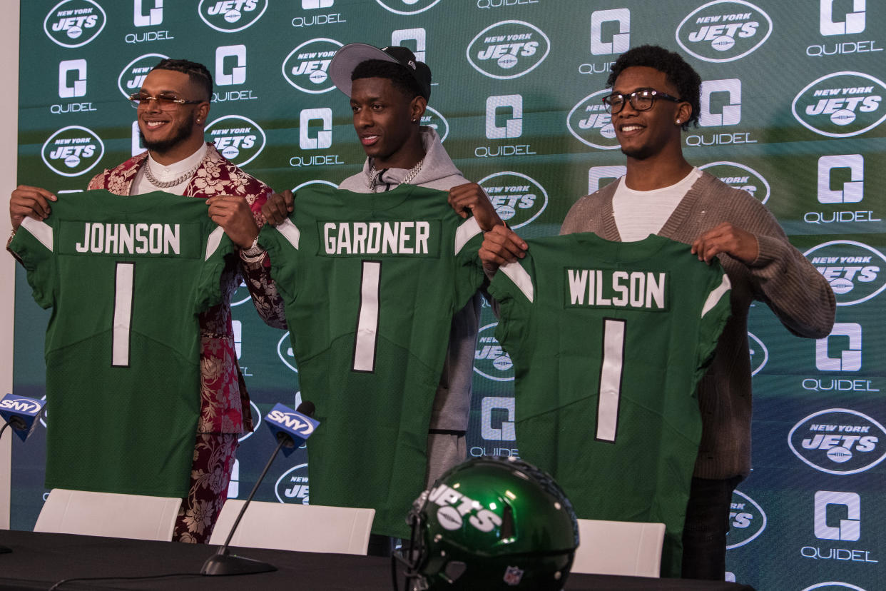 (Left to right) New York Jets first-round picks Jermaine Johnson, Ahmad Gardner and Garrett Wilson display their jerseys. (AP Photo/Brittainy Newman)