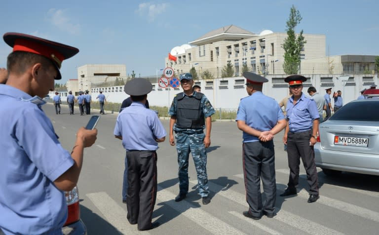 Police officers gather outside the Chinese embassy in the Kyrgyz capital Bishkek on August 30, 2016 following a suicide bombing