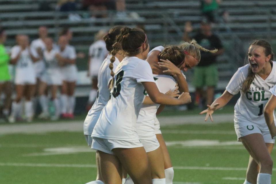 Clear Fork's Brinley Barnett is mobbed by teammates after heading in the game-winning goal with 10 seconds left in a 2-1 win over Madison on Friday.