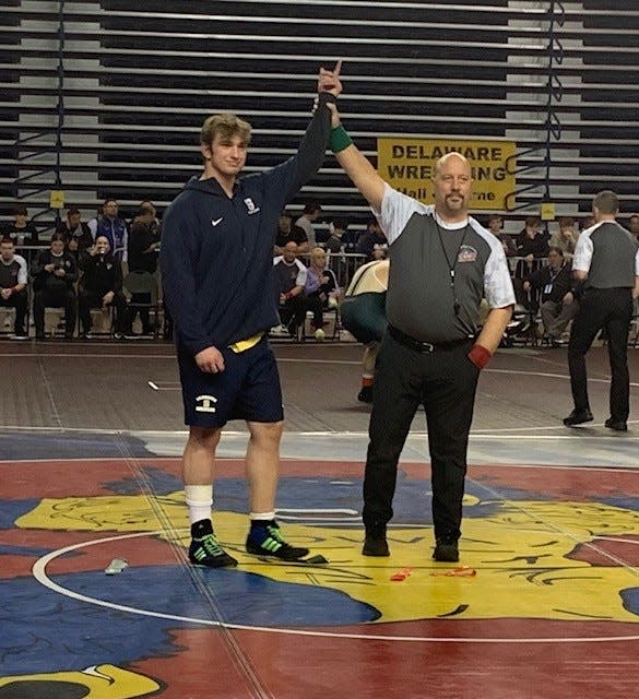 Salesianum senior James Miller has his arm raised after winning 215-pound title at Beast of the East wrestling tournament.