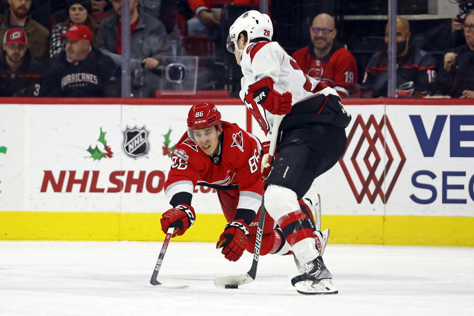 Carolina Hurricanes' Teuvo Teravainen dives to block the shot of New Jersey Devils' Damon Severson during the second period of an NHL hockey game in Raleigh, N.C., Tuesday, Dec. 20, 2022. (AP Photo/Karl B DeBlaker)