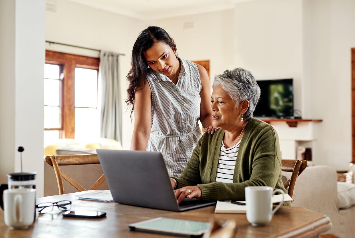 older mother and daughter using the computer