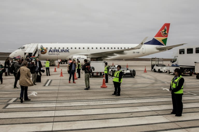 Travellers and passengers get off the first commercial flight from Johannesburg after landing at the newly built Saint Helena Airport on the remote British island