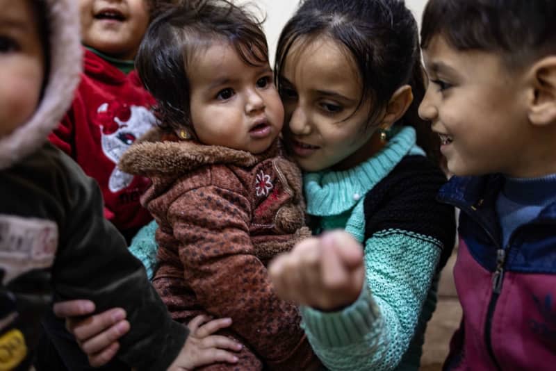 One-year-old Afraa Al-Milihan (middle), also known as the miracle baby, who was born amid the rubble. Al-Milihan now lives with her relatives after losing her family in the February 2023 earthquake that struck southern Turkey and northern Syria. Anas Alkharboutli/dpa