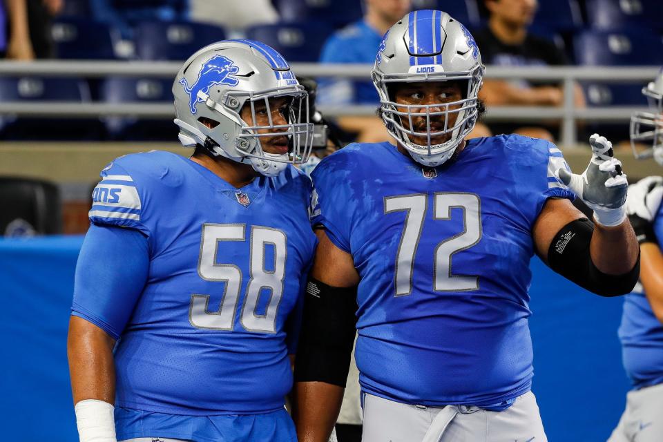 Detroit Lions offensive tackle Penei Sewell (58) talks to  offensive tackle Halapoulivaati Vaitai (72) during warm-ups Friday, Aug, 13, 2021 before a preseason game against Buffalo Bills at Ford Field in Detroit.