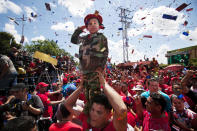 A boy dressed as a soldier salutes during a campaign caravan of Venezuela's President Hugo Chavez from Barinas to Caracas, in Sabaneta, Venezuela, Monday, Oct. 1, 2012. Venezuela's presidential election is scheduled for Oct. 7. (AP Photo/Rodrigo Abd)