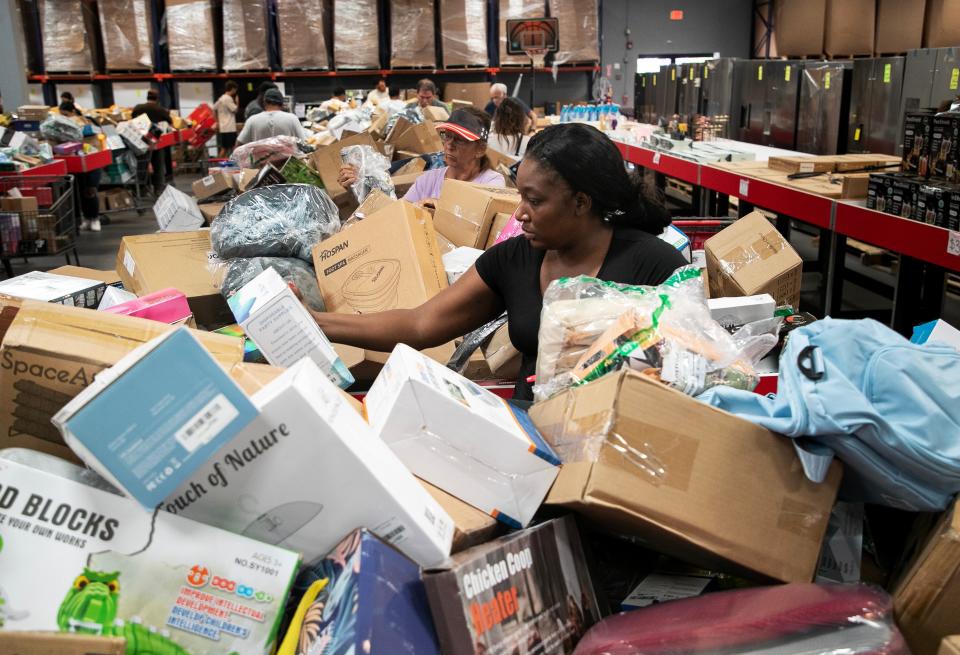 Crystal Thomas searches through bins while shopping at Hotbins in Fort Myers on Friday, Aug. 11, 2023. On Fridays, all of the items in the main bins are $12 and the prices decrease each day until Wednesday when they are $2.