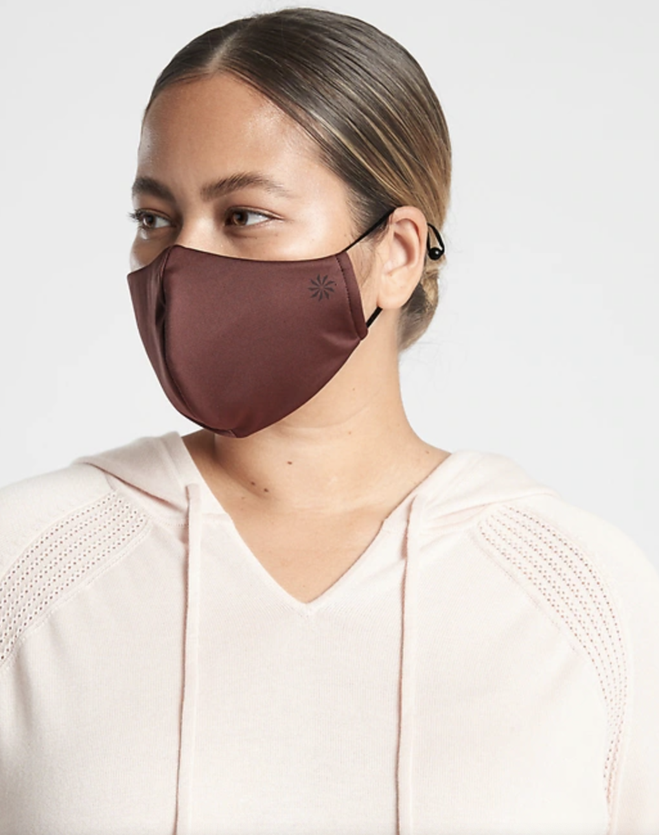blonde woman wearing dark brown burgundy face mask and cream coloured sweater