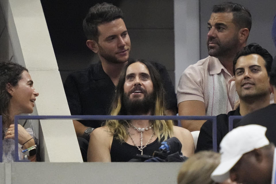 Jared Leto, center, attends a match between Carlos Alcaraz, of Spain, and Daniil Medvedev, of Russia, during the men's singles semifinals of the U.S. Open tennis championships, Friday, Sept. 8, 2023, in New York. (AP Photo/John Minchillo)