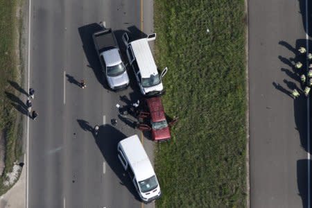 Law enforcement personnel investigate the scene where the Texas bombing suspect blew himself up on the side of a highway north of Austin in Round Rock, Texas, U.S., March 21, 2018. REUTERS/Loren Elliott