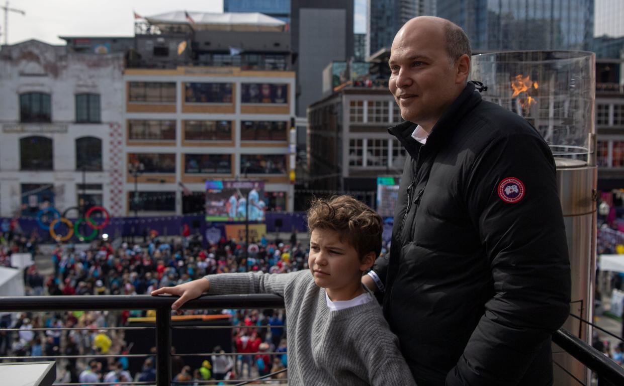Sebastian Moossa, 9, stands with his father, Pierre Moossa during Premier League Fan Fest, off Broadway at Riverfront Park in Nashville, Tenn., Saturday, April 6, 2024.