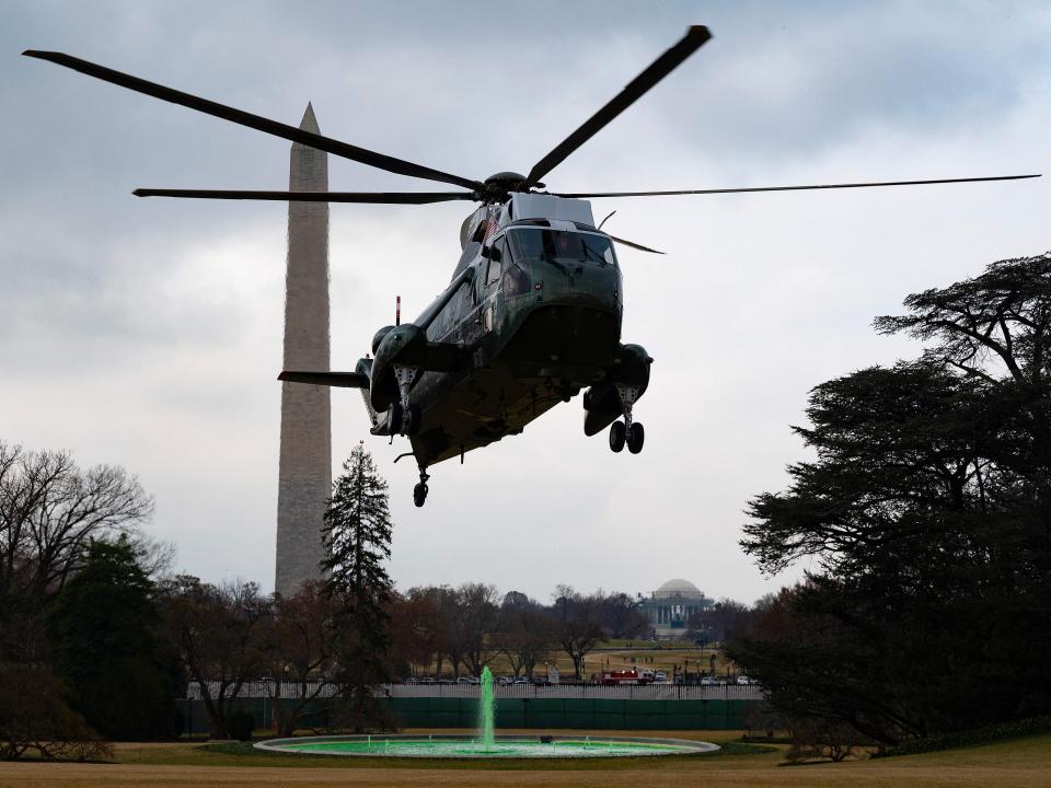 Marine One flies over a green White House fountain on St. Patrick's Day in 2021.