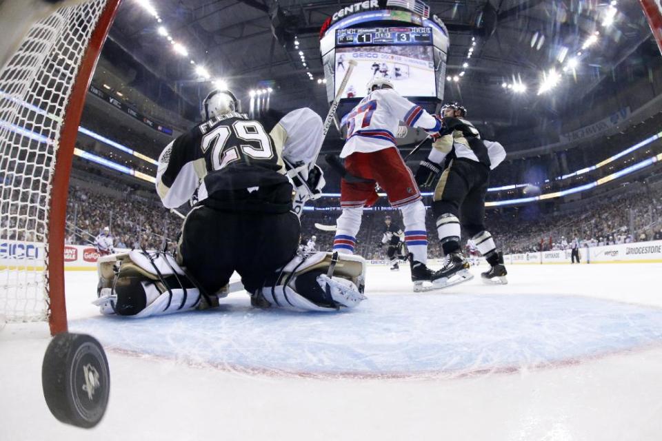 In this photo taken with a fisheye lens, a goal by New York Rangers' Ryan McDonagh (not shown) gets past Pittsburgh Penguins goalie Marc-Andre Fleury (29) in the second period of Game 5 of a second-round NHL playoff hockey series in Pittsburgh Friday, May 9, 2014. The Rangers won 5-1. (AP Photo/Gene J. Puskar)