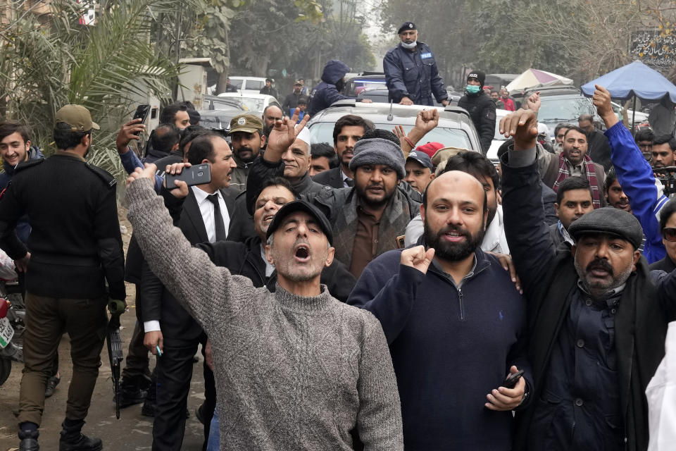 A vehicle carrying Fawad Chaudhry, a senior leader of former Prime Minister Imran Khan's party, is surrounded by media and supporters as it arrives to court in Lahore, Pakistan, Wednesday, Jan. 25, 2023. Police in Pakistan early Wednesday arrested Chaudhry on charges of threatening the chief of the elections overseeing body and other government officials. (AP Photo/K.M. Chaudary)