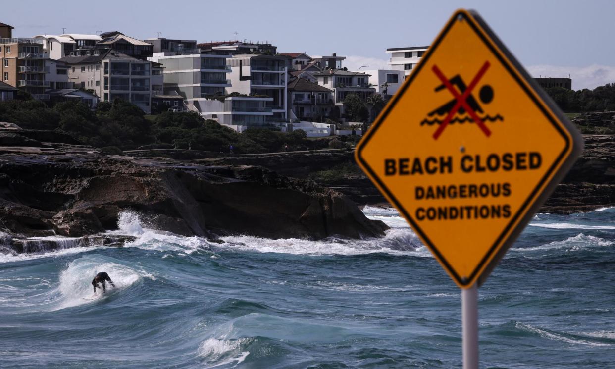 <span>A surfer at Bronte beach in Sydney which was closed on Friday due to dangerous conditions. The NSW coast was hammered again on Sunday.</span><span>Photograph: David Gray/AFP/Getty Images</span>